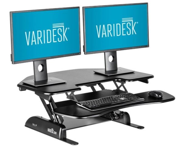 Varidesk Cube Corner 36 black. Adjustable riser with 11 height settings sits on top of your existing desk allowing you to switch from a seated to standing position quickly and easily. The Cube Corner 36 has a triangular display surface 50cm x 91.5cm and